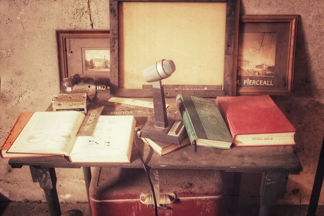 Vintage detective desk with open notebook, magnifying glass and old photographs
